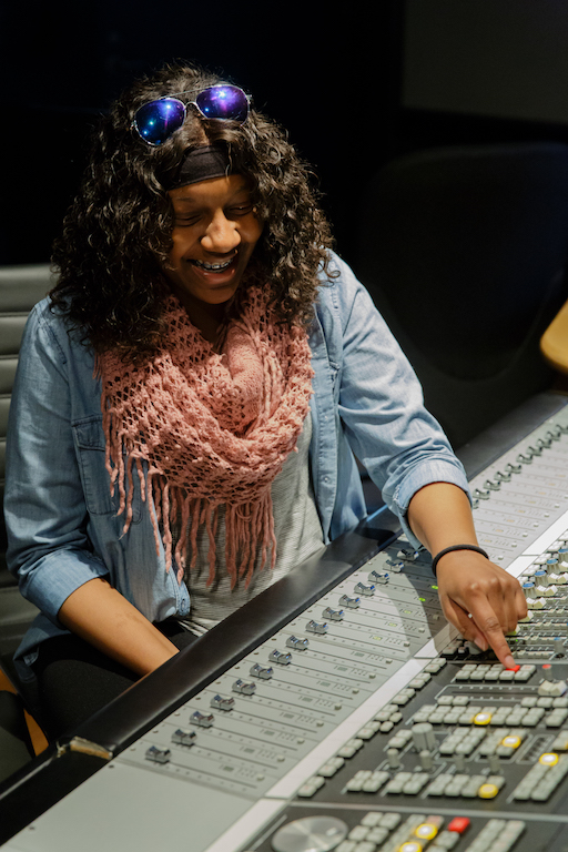 Student at a mixing board at the Clive Davis Institute of Recorded Music